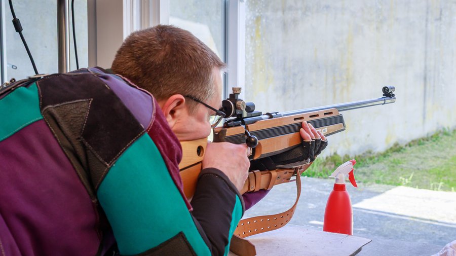 Sportschütze mit Kleinkalibergewehr am Schießstand